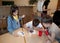 The children painting gingerbread with food paint at a needlework lesson in the children`s camp