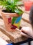 Children are painting potted plants made of pottery