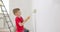 Children painting wall with paint roller and brush