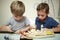 Children painting wooden model of warship