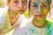 Children with paintings face. Close up portrait of a kids looking at camera. Girls with serious face.