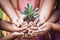 Children and parent holding young tree in hands for planting