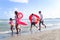 Children with parent wearing colorful inflatable swim ring running on summer beach, kids and adult on tropical sand beach, happy