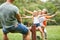 Children and parents are balancing on a swing