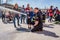 Children and parents at a fire station trying a fire hose.