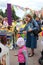 children and parents paint street figures houses in the Park at the city festival