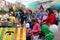 children and parents paint street figures houses in the Park at the city festival