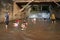 Children and parents play in the water at the bottom of the weir at Faikeng in Pua District.