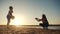 children in the park silhouette playing ball on vacation by the ocean . happy family camping kid concept. dream two