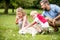 Children petting dog in summer