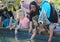 Children petting fish in aquarium