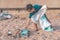 Children picking up Plastic bottle and gabbage that they found on the beach for enviromental clean up concept