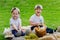 Children at a picnic on a green meadow.