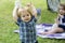 Children on pirnic. Baby child on the green grass in summer park.