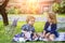 Children on pirnic. Baby playing in green grass. Child having fun on family picnic in summer garden. Brother and sister