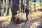 Children play in autumn forest. Little boy and girl friends camping in woods. Brother and sister have fun on fresh air