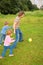 Children play ball with father