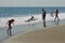 Children Play at the Beach in Ocean Waves
