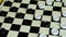 Children play checkers on a colorful table. Boy and girl compete in board games.