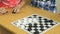 Children play checkers at a kindergarten. Close-up