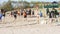Children play handball on the beach.