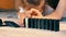 Children play at home in self-isolation during quarantine: build a chain of falling dominoes.