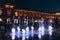 Children play with night fountains in the city of Lodz. Beautiful evening