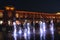 Children play with night fountains in the city of Lodz. Beautiful evening