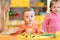 Children play with plasticine in kindergarten