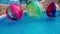 Children play in the pool in inflatable balls