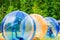 Children play in the pool inside large balls. Favourite children`s water activities - zorbing in the swimming pool. Aquazorbing