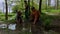 Children play in a puddle at the playground in the park on sunny spring day