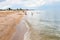 Children play on sand and shelly beach Sea of Azov