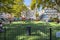 Children play in a small fenced playground school yard in the urban center of Nice France.