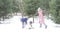 Children play snowballs in the winter forest.