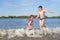 Children play with splashes of water on the river bank.  Golden time.  Beach season