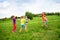 Children play with water guns on a meadow