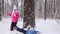 Children play in the winter forest. Slow motion