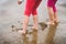 Children playing barefoot sandy beach of Atlantic ocean in Spain