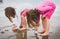 Children playing barefoot sandy beach of Atlantic ocean in Spain