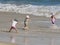 Children playing at the beach, happy days.