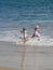 Children playing at the beach, happy days.