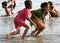 CHILDREN PLAYING AT THE BEACH IN INDONESIA