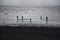 Children playing at the beach in silhouette