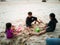 Children playing at the beach on summer holidays. Children building a sandcastle at sea