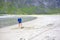 Children, playing on Ersfjords beach in Senja on summer day, running and jumping in the sand and water, northern Norway