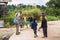 Children playing football with adult man