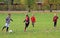 Children are playing football in city park