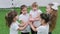 Children playing football indoors. Kids doing a team support. Hand on hand gesture