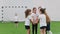 Children playing football indoors. Kids doing a team support. Hand on hand team gesture